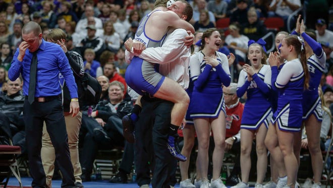 Dike New Hartford senior Trent Johnson celebrates a state win over Sibley-Ocheyedan senior Dylan Schuck in their match at 145 pounds during the Iowa Class 1A wrestling finals on Saturday, Feb. 18, 2017, at Wells Fargo Arena in Des Moines.