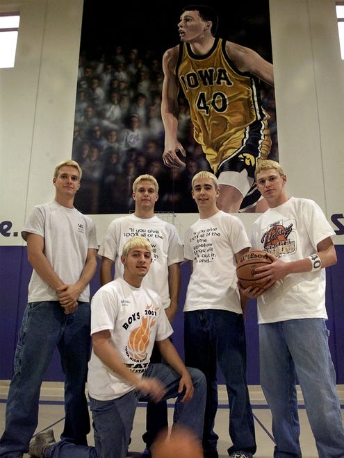 Members of Indianola High School's 2001 state champion basketball team stand in front of the Chris Street mural at the middle school: Kevin Jenkins, kneeling, and, from left, Mark Campbell, Kurt Campbell, Wade McAnelly and Kyle Coppess.