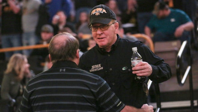 Dan Gable catches up with former Hawkeye and current Wisconsin head coach Barry Davis at Carver-Hawkeye Arena on Friday, Feb. 2, 2018. Davis attended Iowa's dual against Minnesota as one of numerous former Hawkeye wrestlers who were recognized at the dual.