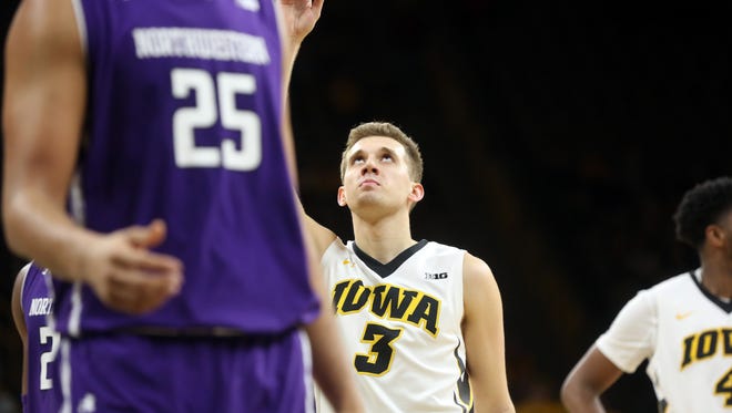 Iowa's Jordan Bohannon points to the sky after keeping Chris Street's consecutive free throw record intact during the Hawkeyes' game against Northwestern at Carver-Hawkeye Arena on Sunday, Feb. 25, 2018.