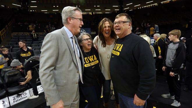 Iowa head coach Fran McCaffery, left, his wife, Margaret, second from left, share a moment with Chris Street's parents, Patty and Mike, following the Hawkeyes' game against Northwestern at Carver-Hawkeye Arena on Sunday, Feb. 25, 2018.