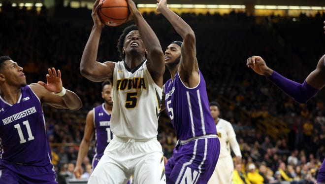 Iowa's Tyler Cook fights his way to the basket during the Hawkeyes' game against Northwestern at Carver-Hawkeye Arena on Sunday, Feb. 25, 2018.
