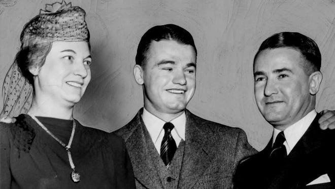 Feb. 14, 1940 - Nile Kinnick with his parents at the presentation of the Chicago Tribune's most valuable Big Ten player award at the all-Iowa banquet in Iowa City.