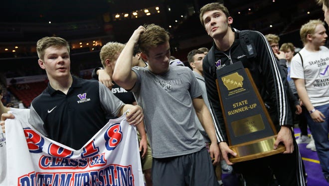 Waukee wrestlers hold their state runner up trophy Wednesday, Feb. 14, 2018, at the 2018 Dual Team Wrestling championships in Des Moines.
