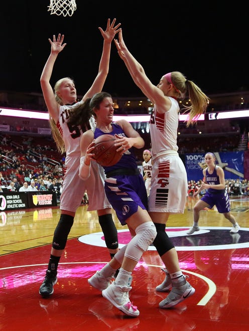 Indianola senior Grace Berg grabs a rebound between Cedar Falls senior Cynthia Wolf and sophomore Emerson Green. Seventh-seeded Indianola beat second-seeded Cedar Falls 64-63 in a Class 5A state quarterfinal at Wells Fargo Arena in Des Moines Feb. 26.