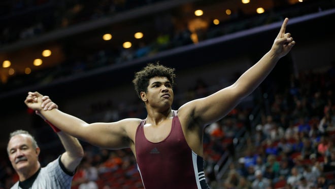 Mount Vernon's Tristan Wirfs celebrates his win in the class 2A, 220-pound title match Saturday, Feb. 18, 2017 in the state wrestling finals at Wells Fargo Arena in Des Moines.