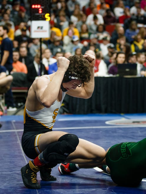 Cade DeVos of Southeast Polk celebrates a 7-2 victory over Mason Hulse of Boone during their class 3A 145 pound championship match at Wells Fargo Arena on Saturday, Feb. 17, 2018, in Des Moines.