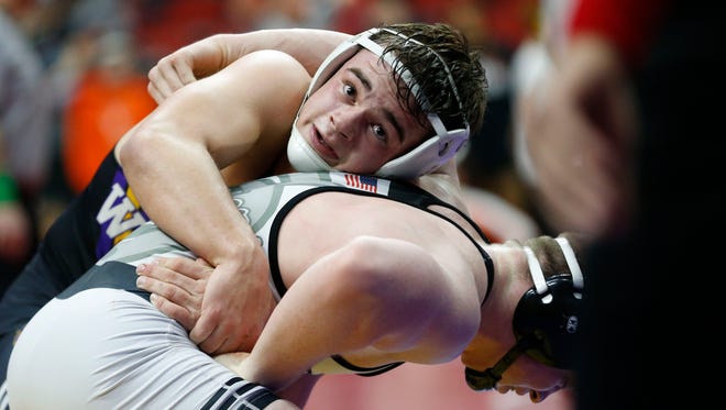 Waukee's Brandon Tessau looks up at the time as he wrestles with Fort Dodge's Kaden Smith Wednesday, Feb. 14, 2018, in their class 3A match at the 2018 Dual Team Wrestling championships in Des Moines.
