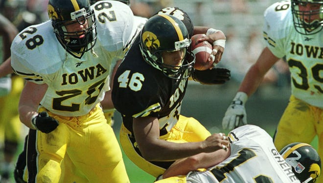From 1998: Hawkeyes running back Ladell Betts gains some of his 79 yards Iowa's spring football game. The first team won, 23-0. Others pictured: Cody O'Hare (28), Mike Dolezal (39) and Jesse Ghere.