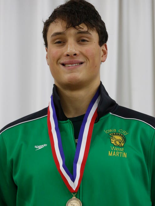 Iowa City West's Oliver Martin smiles from the top of the podium Saturday, Feb. 11, 2017 after winning the the 50 yard freestyle at the 2017 boys state swim meet in Marshalltown.