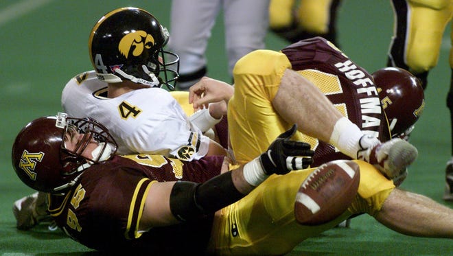 From 1998: Iowa quarterback is Kyle McCann is sacked by Minnesota defensive lineman Jon Michals in the Hawkeyes final game of the season, which was also the last game Hayden Fry coached for the Hawkeyes.