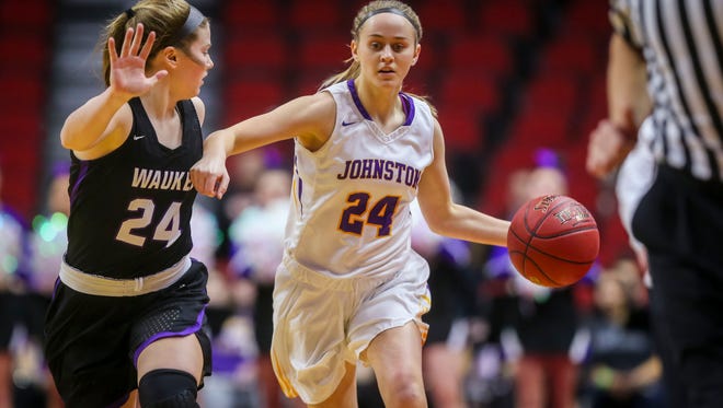 Johnston's (24) Macy Thompson drives the ball against Waukee's (24) Jori Nieman during their first round 5A matchup in the girls' state basketball tournament Monday, Feb. 26, 2018, at Wells Fargo Arena in Des Moines, Iowa.