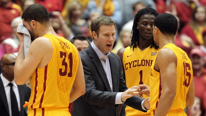 Iowa State Cyclones head coach Fred Hoiberg talks to forward Georges Niang (31) and guard Naz Long (15) and forward Jameel McKay (1) during their game against the Kansas State Wildcats at James H. Hilton Coliseum. The Cyclones beat the Wildcats 77-71.