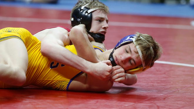 Lisbon's Cael Happel controls Wapello's Devon Meeker in their 1A state title match at 113 pounds during the Iowa Class 1A wrestling finals on Saturday, Feb. 18, 2017, at Wells Fargo Arena in Des Moines.