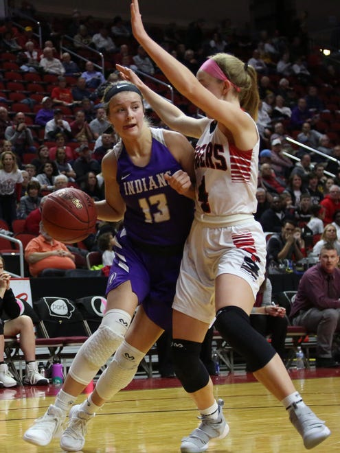 Indianola junior Maggie McGraw tries to fight her way past Cedar Falls sophomore Emerson Green. Seventh-seeded Indianola beat second-seeded Cedar Falls 64-63 in a Class 5A state quarterfinal at Wells Fargo Arena in Des Moines Feb. 26.