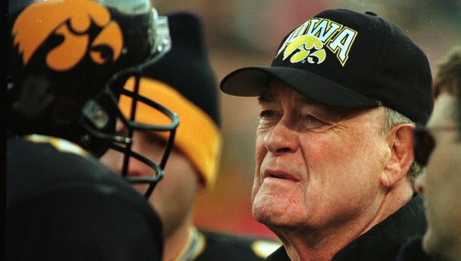 From 1998: Hayden Fry talks with Kyle McCann on the sideline during their loss to Ohio State.