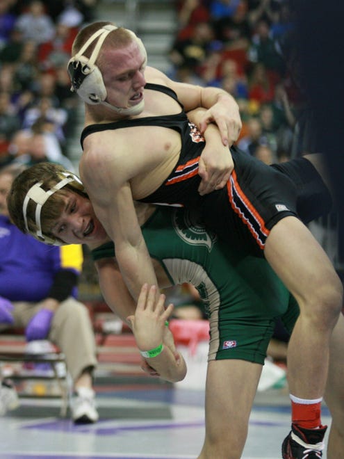 2011: Iowa City West's Jack Hathaway picks up West Des Moines Valley's Kyle Larson during their 125 pound match in the semifinals for the Class 3A state wrestling tournament.