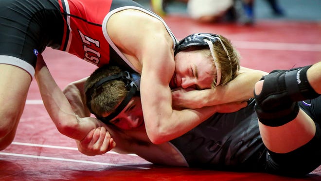 Cael Happel of Lisbon, left, controls Quest Brown of West Central Valley at 113 pounds on Thursday.