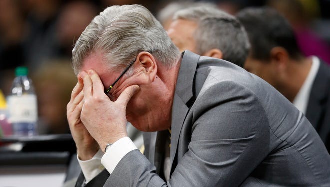 Fran McCaffery buries his head in his hands during the second half of Iowa's 77-73 loss to Penn State at Carver-Hawkeye Arena.