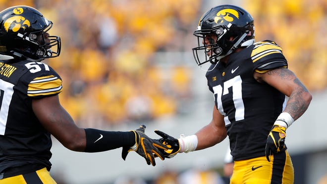 Iowa defensive back Amani Hooker, right, celebrates with teammate Chauncey Golston after intercepting a pass during the first half of an NCAA college football game against Northern Illinois, Saturday, Sept. 1, 2018, in Iowa City, Iowa. (AP Photo/Charlie Neibergall)