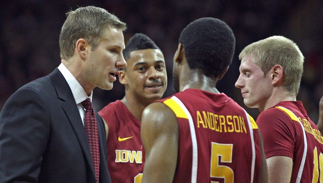 Coach Fred Hoiberg, left, talks with Diante Garrett, Jake Anderson and Scott Christopherson during a  game against Iowa on Dec. 10, 2010, in Iowa City.