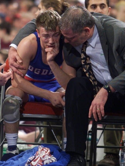 From 2001: Ogden Coach Brian Reimers speaks with 119-pounder Jesse Sundell after Sundell won his fourth state championship Saturday at Veterans Memorial Auditorium. Sundell became the 12th  wrestler to capture four Iowa state titles.
