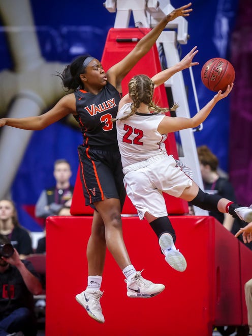 West Des Moines Valley's (3) Zoe Young tries to block Iowa City High's (22) Paige Rocca during their first round 5A matchup in the girls' state basketball tournament Monday, Feb. 26, 2018, at Wells Fargo Arena in Des Moines, Iowa.