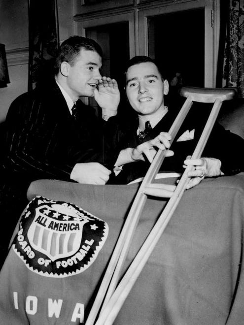 Nile Kinnick whispers encouragement to Edwin 'Rip' Collins as they meet at the Iowa Alumni Society Dinner at the Western University Club in New York Jan. 13, 1940. Kinnick gave his all-American blanket to Collins, who had to have a leg amputated after an accident in a New Jersey high school football game.