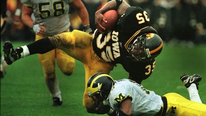 From 1998: Iowa's Trevor Bollers  is stopped by Michigan's DeWayne Patmon after catching a 25-yard pass from Kyle McCann. The Hawkeyes led, 9-7, at halftime but Michigan came back to win, 12-9.