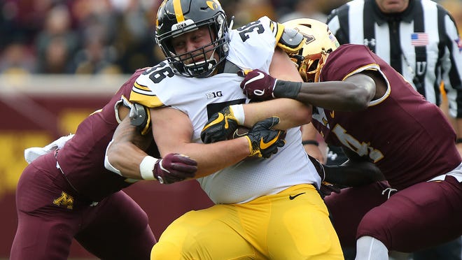 Iowa linebacker Mitch Riggs is tackled by Minnesota ' s Terell Smith during a game played Oct. 6, 2018 in Minneapolis.