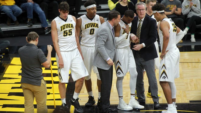 Iowa head coach Fran McCaffery helps Maishe Dailey after big fall during the Hawkeyes' game against Northern Illinois at Carver-Hawkeye Arena on Friday, Dec. 29, 2017.