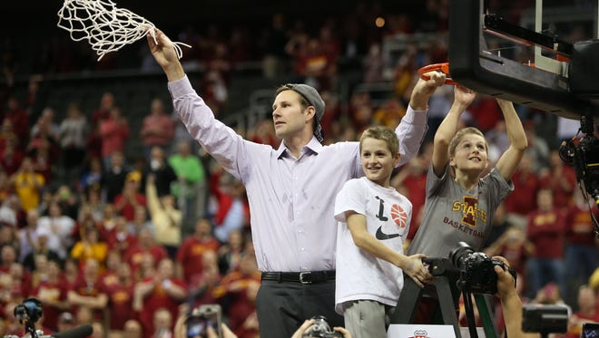 Iowa State head coach Fred Hoiberg cuts down the net with his two boys after the Big 12 Championship title game between Iowa State and Kansas on Saturday, March 14, 2015, outside the Sprint Center in Kansas City, Missouri.