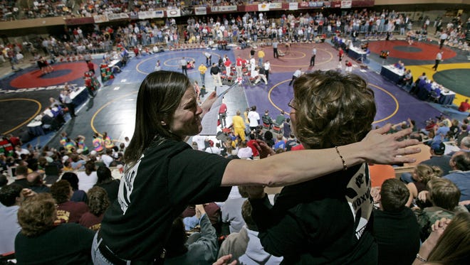 From 2004: Joni Swanson, left, and Melinda Dunkin, both of Knoxville, embrace each other after watching Dunkin's son Chris win a 171-pound quarterfinal match over Tylor Pilcher of Fairfield during the state wrestling tournament at Veterans Memorial Auditorium. Earlier, Swanson's son Josh won his 140-pound quarterfinal match over Kalvin Hodge of Iowa City West.