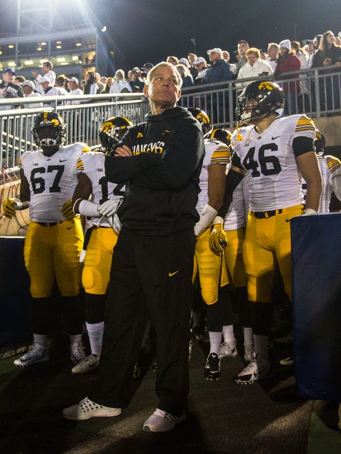 Iowa coach Kirk Ferentz leads his players out of the tunnel at Penn State on Nov. 5. Pictured are three Hawkeyes expected to be drafted in the first four rounds in Jaleel Johnson (67), Desmond King (14) and George Kittle (46).