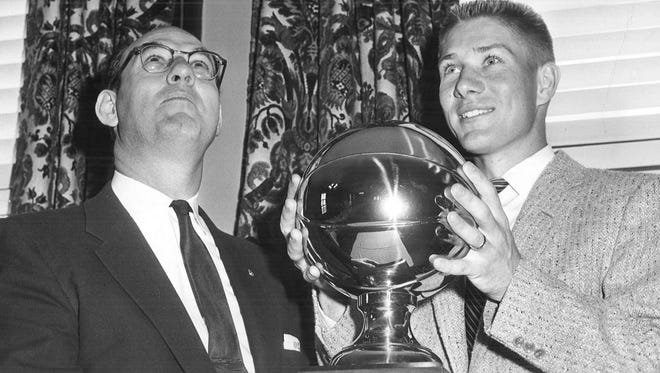 Gary Thompson, right, poses with his trophy for being named 1957 Iowa Outstanding Amateur Player.