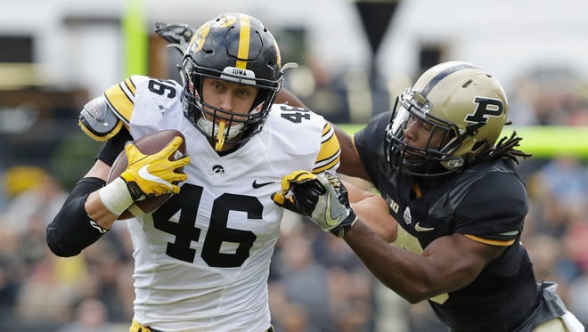 Iowa's George Kittle (46) runs past Purdue's Leroy Clark during the first half of an NCAA college football game, Saturday, Oct. 15, 2016, in West Lafayette, Ind. (AP Photo/Darron Cummings)