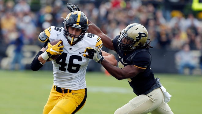 Iowa Hawkeyes tight end George Kittle (46) runs past Purdue Boilermakers safety Leroy Clark (3) at Ross Ade Stadium.