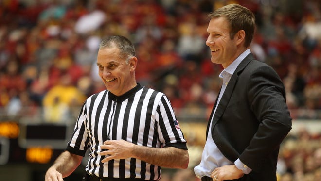 Coach Fred Hoiberg shares a laugh with a game official in the second half against Oklahoma State on Jan. 6, 2015, in Ames.