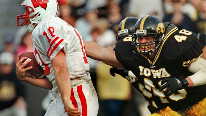 From 1998: Wisconsin quarterback Mike Samuel slips past Iowa's Ryan Loftin for a third-quarter touchdown.
