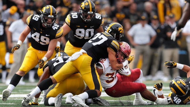 FILE - In this Sept. 8, 2018, file photo, Iowa defensive back Amani Hooker, center, tackles Iowa State running back David Montgomery, right, during the first half of an NCAA college football game,in Iowa City, Iowa. The 18th-ranked Wisconsin Badgers (2-1) haven’t been the dominant team everyone expected them to be and, following their home loss to BYU, are looking to reset the season in their Big Ten opener against Iowa. Iowa (3-0) has been one of the most dominant defensive teams in the nation. (AP Photo/Matthew Putney, File)