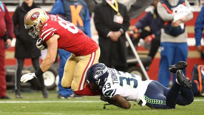 SANTA CLARA, CA - DECEMBER 16: George Kittle #85 of the San Francisco 49ers is tackled by Tedric Thompson #33 of the Seattle Seahawks after a catch during their NFL game at Levi's Stadium on December 16, 2018 in Santa Clara, California. (Photo by Ezra Shaw/Getty Images)