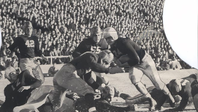 University of Iowa ’ s Nile Kinnick (24) scores a 3-yard touchdown Nov. 11, 1939, in the Hawkeyes ’ 7-6 home victory against then-No. 3 Notre Dame.
