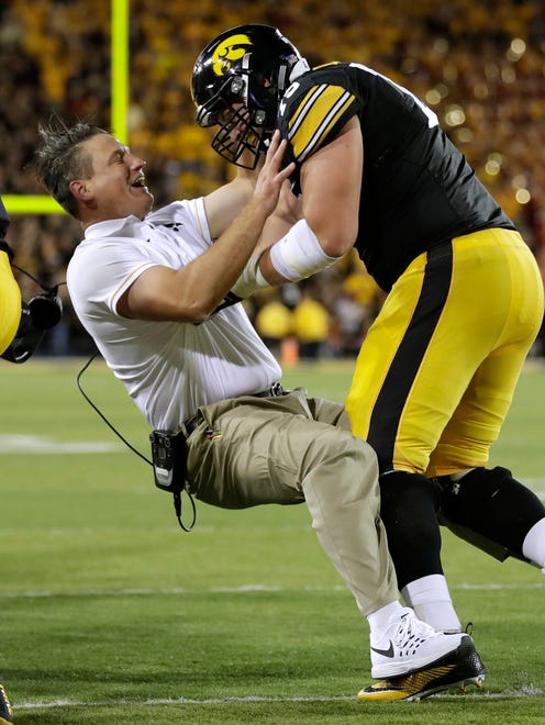 Iowa assistant coach Brian Ferentz celebrates with lineman Ike Boettger, right, after an Iowa touchdown during the second half of an NCAA college football game against Iowa State, Saturday, Sept. 10, 2016, in Iowa City, Iowa. Iowa won 42-3.