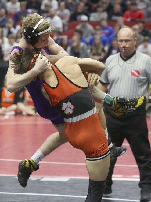 Indianola senior 120-pounder Connor Sexton (in purple) wrestles West Des Moines Valley senior Noah Hughes-Reilly in a Class 3A opening-round match at the state wrestling meet Feb. 16 at Wells Fargo Arena in Des Moines.