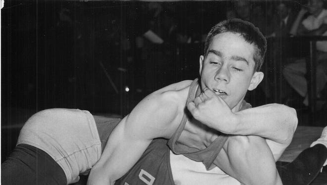 1953: North's Grant Jordan appears to have an advantage over Dale Wayman (with helmet) of Tech Friday as they wrestle in the 129-pound division at the city meet. Jordan won a 10-3 decision.