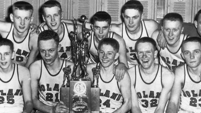 Gary Thompson, center right holding the trophy, celebrates with teammates after finishing second in the 1951 state tournament. Roland lost to Davenport in the championship game.