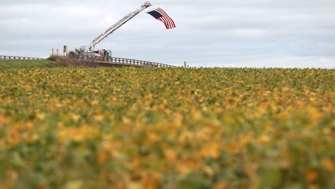 An American flag waves over Interstate 380 on Thursday, Sept. 11, 2014. The flag was displayed by the North Liberty Fire Department throughout the day to honor those who lost their lives on Sept. 11, 2001.