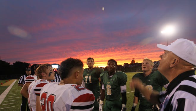 City High and West High players line up for the coin toss before their game at West High on Friday, Sept. 16, 2016. In the six year's I've worked for the Press-Citizen, this was the first time I ever photographed the coin toss at a high school game. I only shot it because of the beautiful sky behind the players and got lucky that the stadium lights reflected off the coin.
