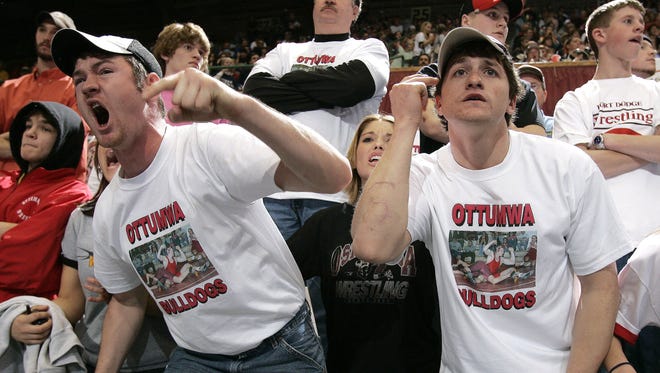 From 2004: Ottumwa fans Ryan Reed, left, Ashley Frazier, center and Travis Simpson, right, cheer on Reed's brother, Tyler, during a 171-pound Class 3A quarterfinal match against Austin Boehm of Urbandale during state wrestling at Veterans Memorial Auditorium.