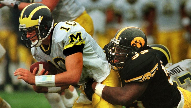 From 1998: Iowa defender Anthony Herron sacks Michigan quarterback Tom Brady for loss of two yards late in first half. The Hawkeyes led, 9-7, at halftime but Michigan came back to win, 12-9.